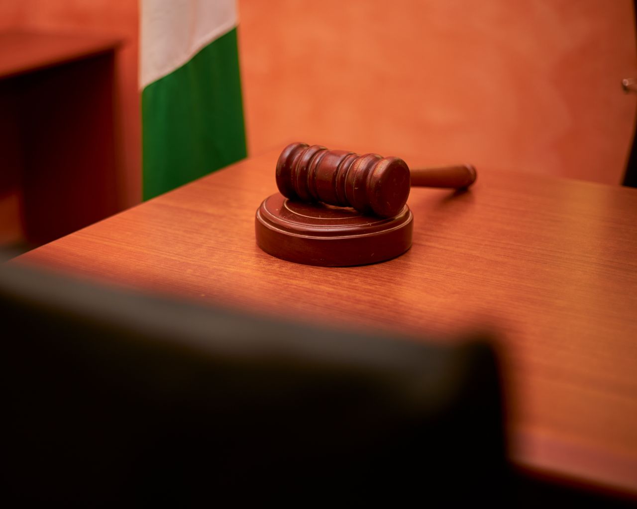 Home A close-up of a gavel on a courtroom desk representing law and justice.