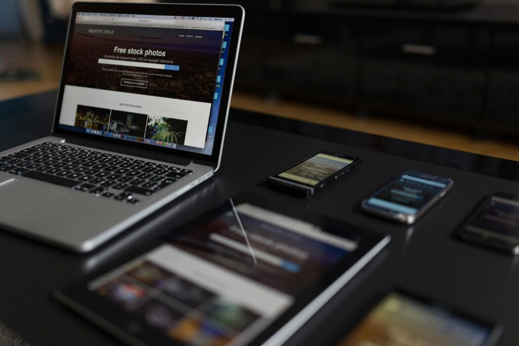 pexels photo 34140 A contemporary workspace showcasing a laptop, tablet, and smartphones, ideal for tech and freelance use.